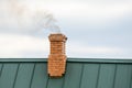 Smoke from the chimney, heating. smoke billowing. coming out of a house chimney against a blue sky background Royalty Free Stock Photo