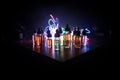 Smoke clouds and vape liquid bottles on dark background. Light effects. Useful as background or vape advertisement or vape Royalty Free Stock Photo