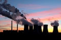 Smoke of coal power plant under sunset sky