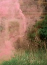 pink smoke from the air, colorful smoke in the field and ancient building