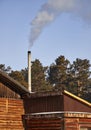 smoke coming from the chimney of a village house Royalty Free Stock Photo