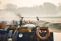 Smoke coming from chimney of wood log burning narrow canal boat on misty morning river scene with lifebuoy orange preserver ring Royalty Free Stock Photo