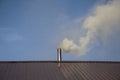 Smoke coming out the chimney against sky Royalty Free Stock Photo