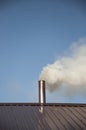 Smoke coming out the chimney against sky Royalty Free Stock Photo