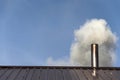 Smoke coming out the chimney against sky Royalty Free Stock Photo