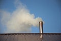 Smoke coming out the chimney against sky Royalty Free Stock Photo