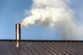 Smoke coming out the chimney against sky Royalty Free Stock Photo