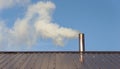 Smoke coming out the chimney against sky Royalty Free Stock Photo