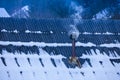 Smoke coming out from chimney on a house roof. Royalty Free Stock Photo