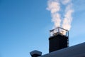 Smoke coming out of the house chimney, heating in cold winter day