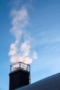 Smoke coming out of the house chimney, heating in cold winter day