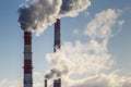 Smoke coming from three factory chimneys. Global warming. Air pollution Royalty Free Stock Photo