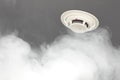 Smoke detector on ceiling, fire alarm in action Royalty Free Stock Photo