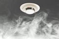 Smoke detector on ceiling, fire alarm in action Royalty Free Stock Photo
