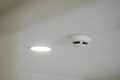 Smoke detector and ceiling light installed in modern room Royalty Free Stock Photo