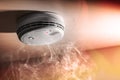 Smoke detector and interlinked fire alarm in action background Royalty Free Stock Photo