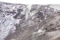 Smoke in Escriva crater on volcano Etna in snow in winter, Sicily, Italy