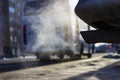 Smoke from the exhaust pipe of the car in the winter cold season Royalty Free Stock Photo