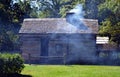 Smoke exits chimney of pioneer cabin Royalty Free Stock Photo