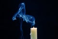 Smoke from an extinguished candle on a dark background. The concept of spirituality and the end of life Royalty Free Stock Photo