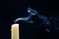 Smoke from an extinguished candle on a dark background. The concept of spirituality and the end of life Royalty Free Stock Photo