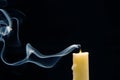 Smoke from an extinguished candle on a dark background. The concept of spirituality and the end of life Royalty Free Stock Photo