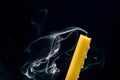 Smoke from an extinguished candle on a dark background. The concept of spirituality and the end of life Royalty Free Stock Photo