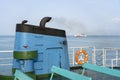 Smoke from ferry boat flue during sea with sunlight, sea water and clear sky in background, Thailand