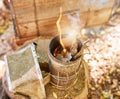 Smoke, fire and metal container on bee farm for agriculture, smoking and honey production. Farming, vintage and