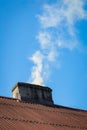 Smoke flying over chimney of countryside house