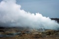 Smoke from the ground in geothermal area in the icelandic countryside.