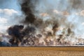 Smoke in harvested field catching fire