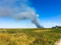 Smoke on the horizon. A fire is burning in the field. Autumn landscape Royalty Free Stock Photo