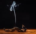 Smoke incense stick, smoke on a black background.