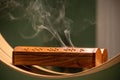 Aromatic smoke coming from natural wooden box with holes used for spiritual ceremonies, relaxation