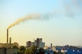 Smoke from an industrial pipe on a city and a forest. bad ecology, pollution of the environment. Royalty Free Stock Photo