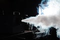 Smoke machine in action. Smoke in the dark. Royalty Free Stock Photo