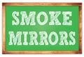 SMOKE MIRRORS words on green wooden frame school blackboard