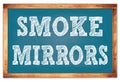 SMOKE MIRRORS words on blue wooden frame school blackboard