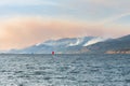 Smoke from multiple forest fires in the mountains above Naramata viewed from across Okanagan Lake