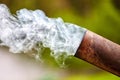Smoke from an old rusty metal pipe from a street stove, hearth Royalty Free Stock Photo