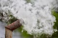 Smoke from an old rusty metal pipe from a street stove, hearth Royalty Free Stock Photo