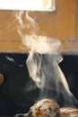 Smoke pattern bellowing out of a roasted brinjal