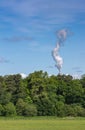 Smoke plume of power plant over trees in rural South Scotland, U Royalty Free Stock Photo