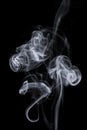 Smoke puffs over black background