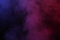 Artificial magic smoke in red-blue light on black background Royalty Free Stock Photo