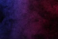 Artificial magic smoke in red-blue light on black background Royalty Free Stock Photo