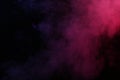 Artificial magic smoke in red-blue light on black background Royalty Free Stock Photo