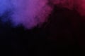 Artificial magic smoke in red-blue light on black background Royalty Free Stock Photo