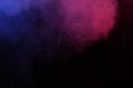 Artificial magic smoke in red-blue light on black background Royalty Free Stock Photo